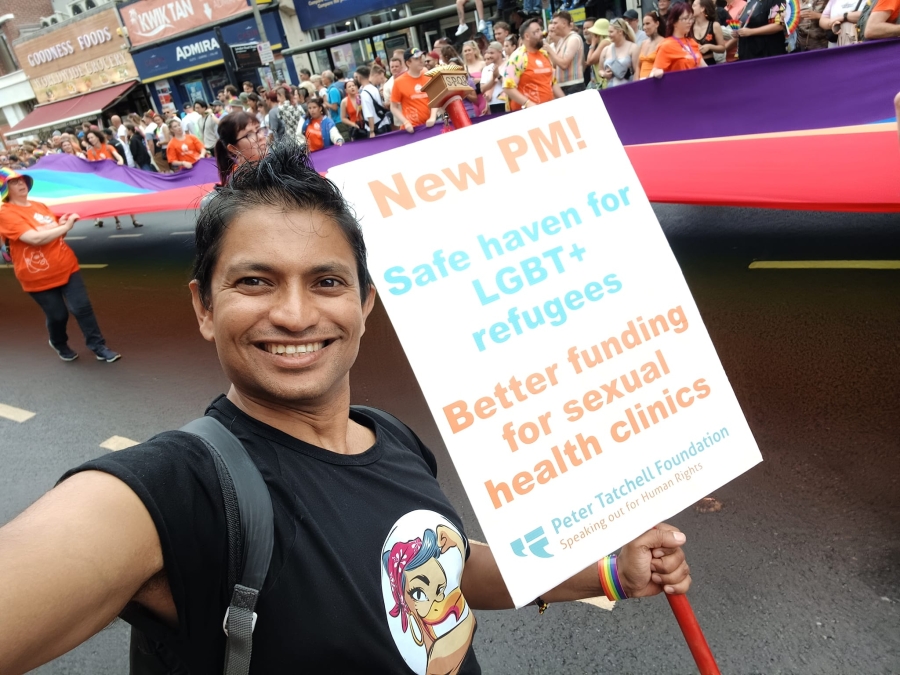 Man holding banner at gay pride march